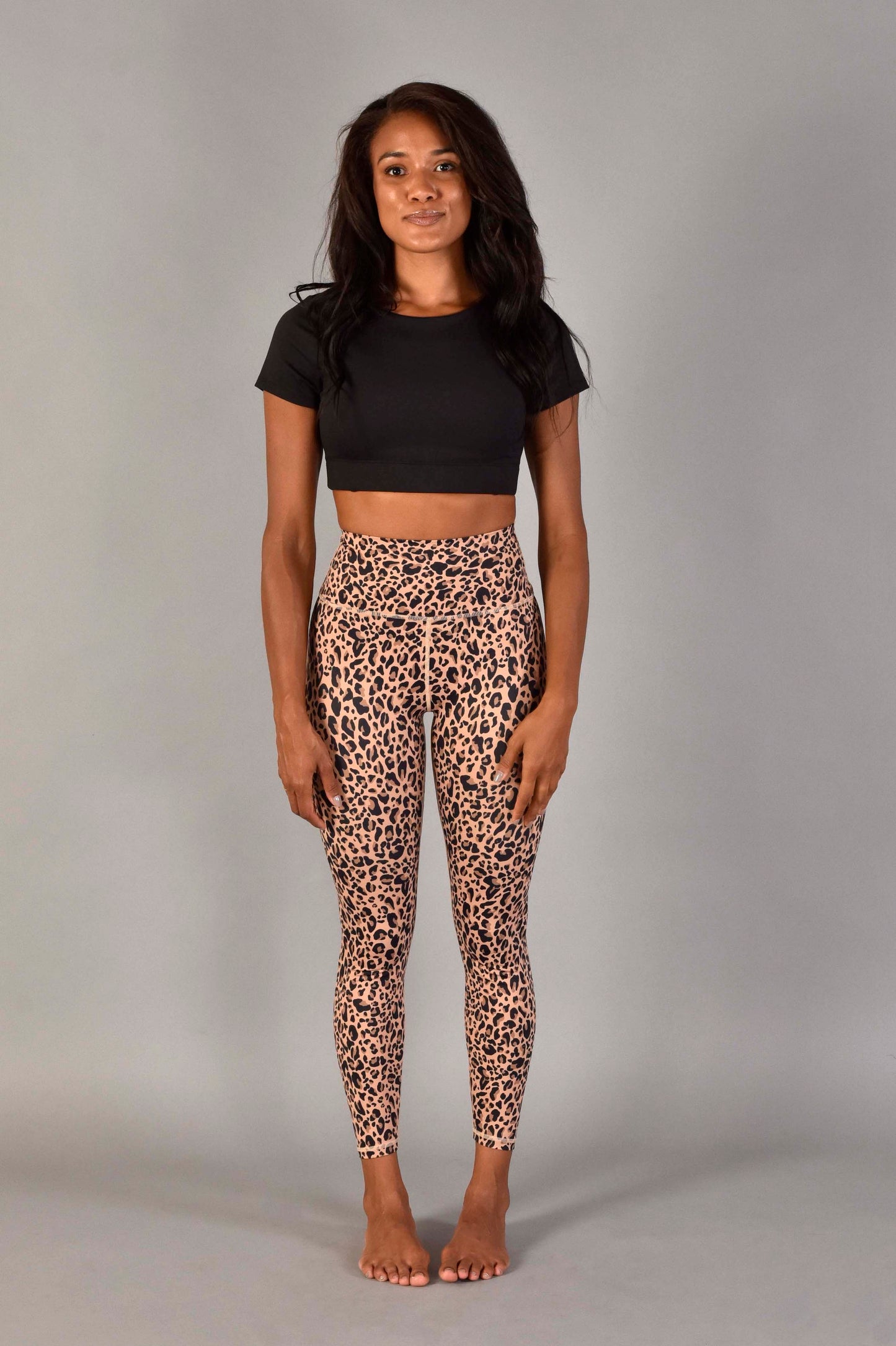 WEAWEAR LOVE MORE Designer Sustainable Activewear. Ultra High Rise Recycled Luxe 7/8 Legging in Nude Leopard. Paired with Audrey Top in Matte Black. Leopard Print Legging. Nude Leopard Print Legging.