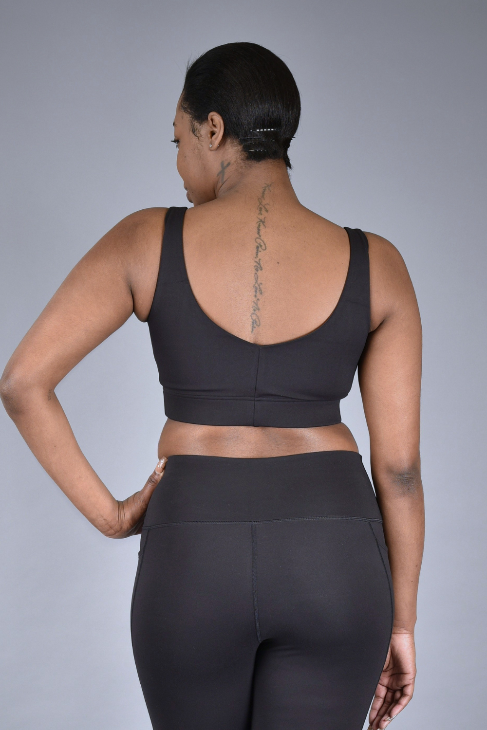 Wear Love More black Brigitte medium support square-neck sports bra with wide v-back in recycled core compression fabric.