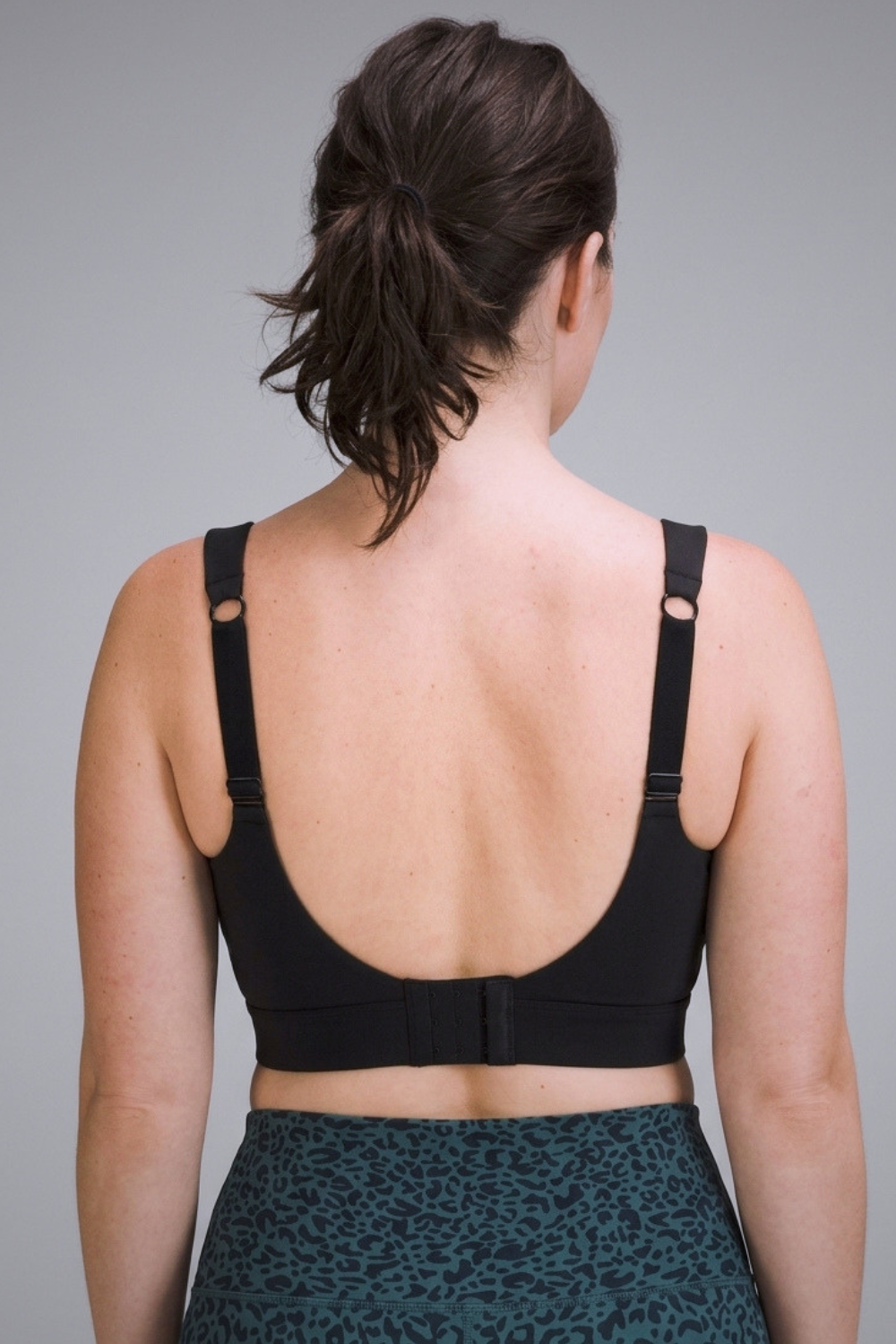 Wear Love More black Veda high support v-neck sports bra  in recycled core compression fabric.