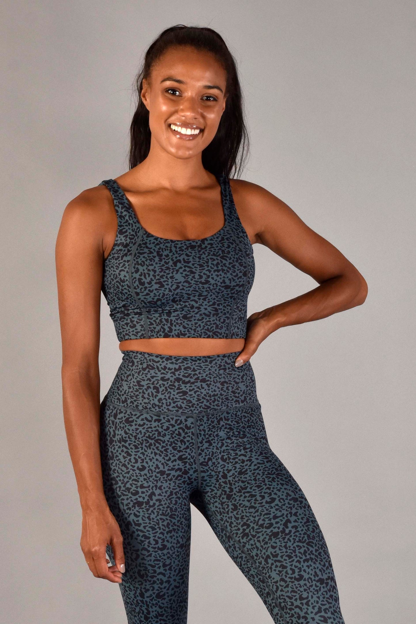 WEAR LOVE MORE Designer Sustainable Activewear.  Sophia Longline Bra in Emerald Leopard.  Dark Blue Green Leopard Print Bra Support Top.  Paired with 7/8 Emerald Leopard Legging.  Luxury Recycled Performance Fabric.