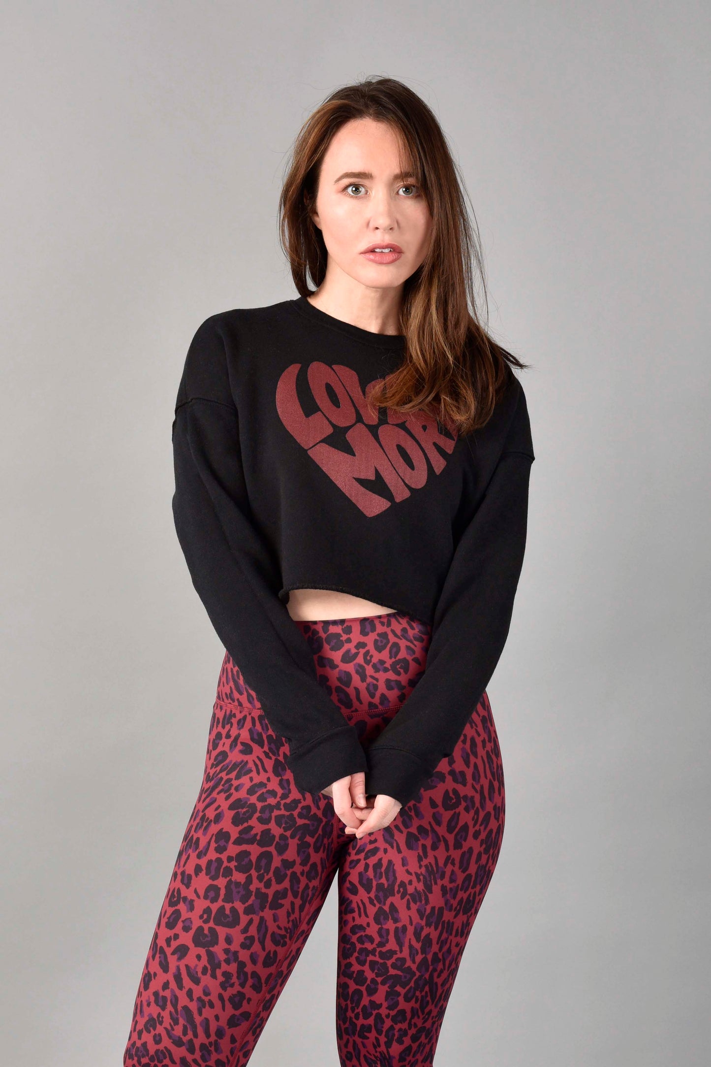 WEAR LOVE MORE Love More Crop Sweatshirt.  Cropped Sweatshirt with Signature Love More Heart Graphic in Red.
